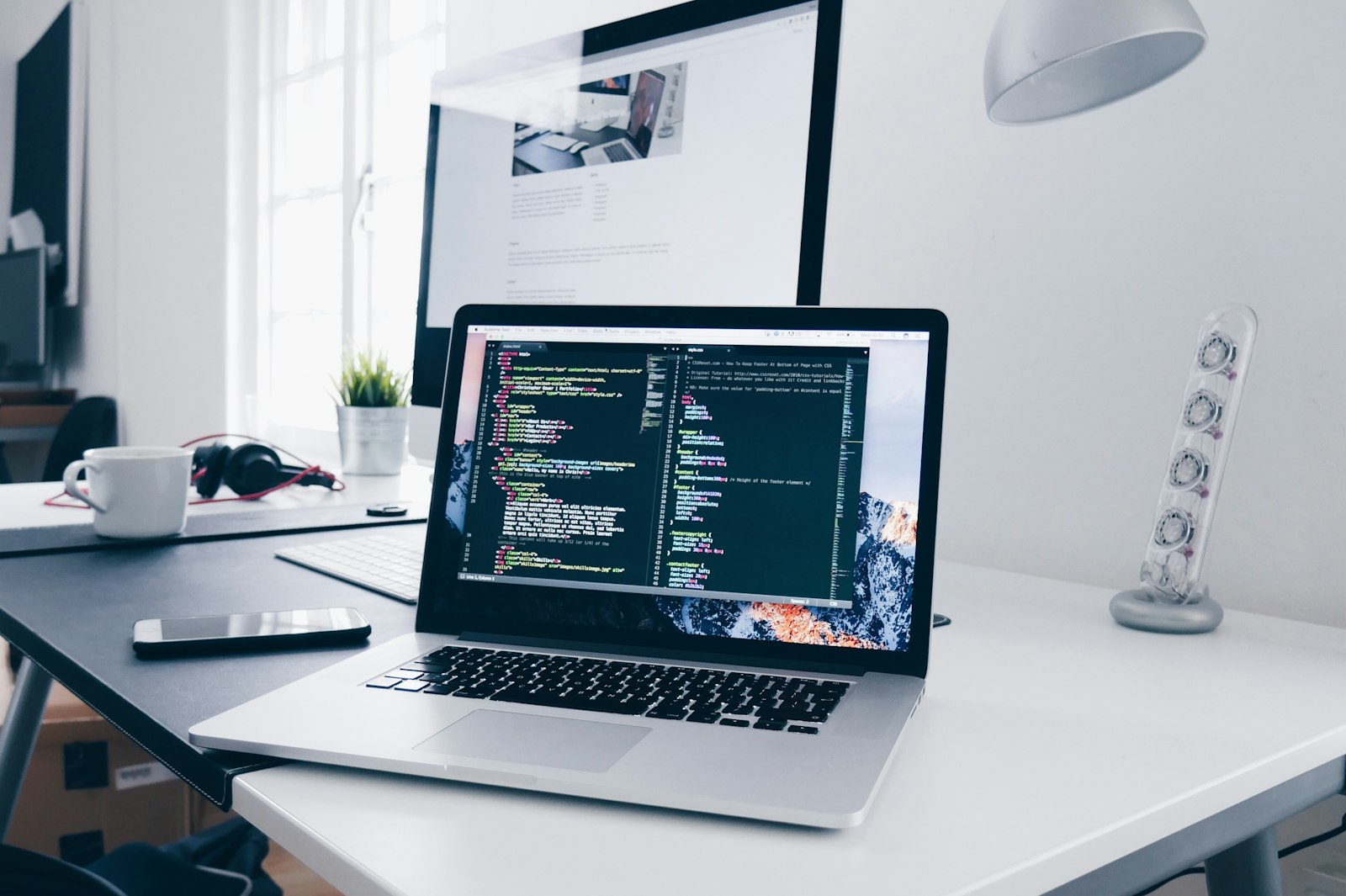 A developer desk with code on screen, the kind of environment custom software is built in