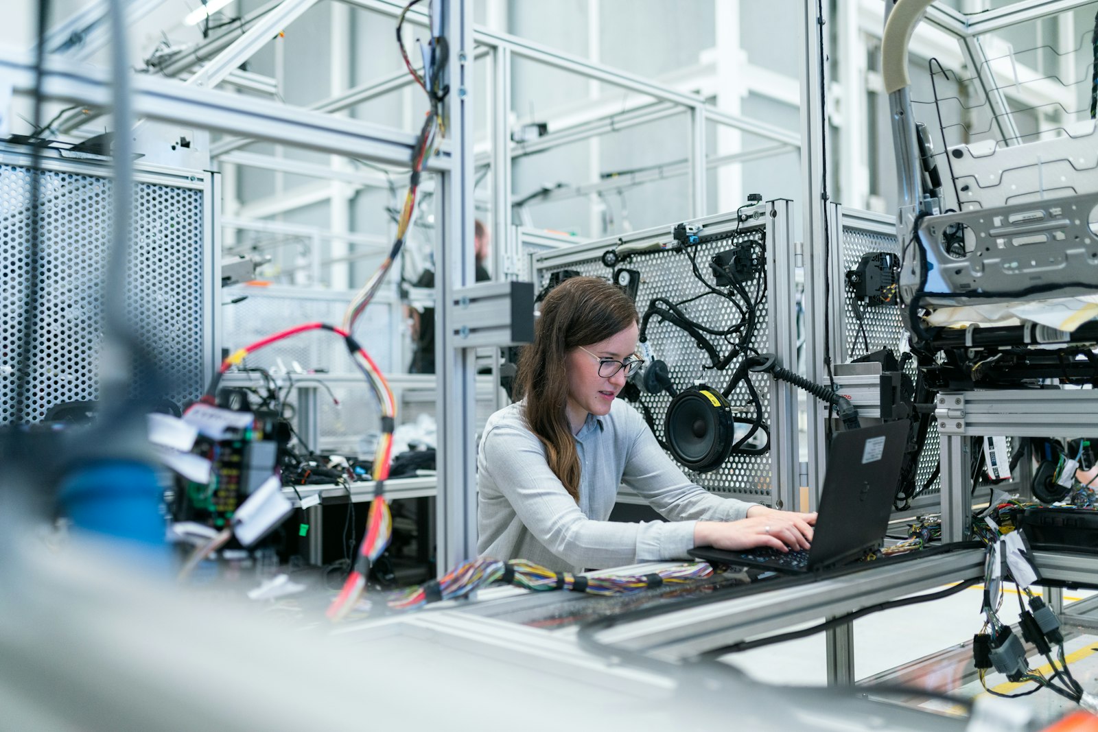 An electronics engineer inspecting a wired test rig during device development